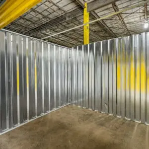 A warehouse with metal walls and yellow ceiling.