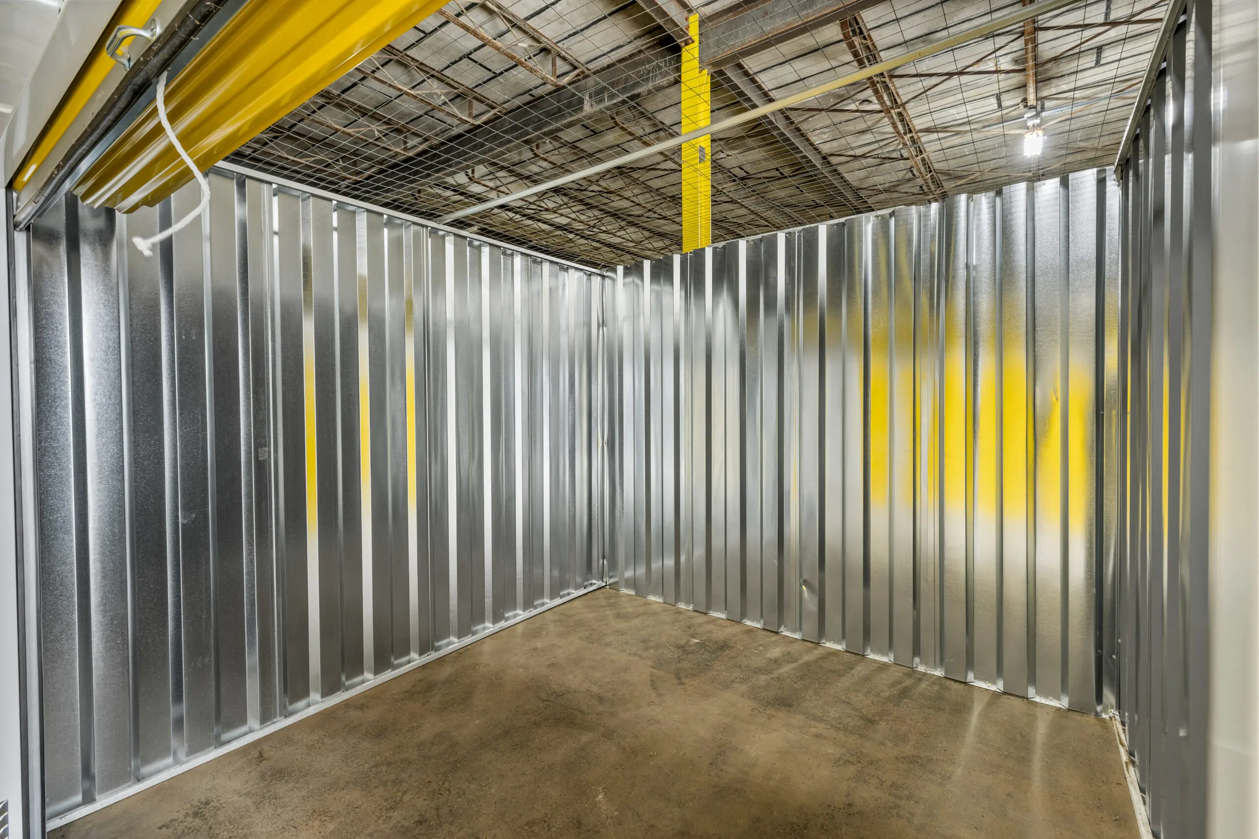 A warehouse with metal walls and yellow ceiling.