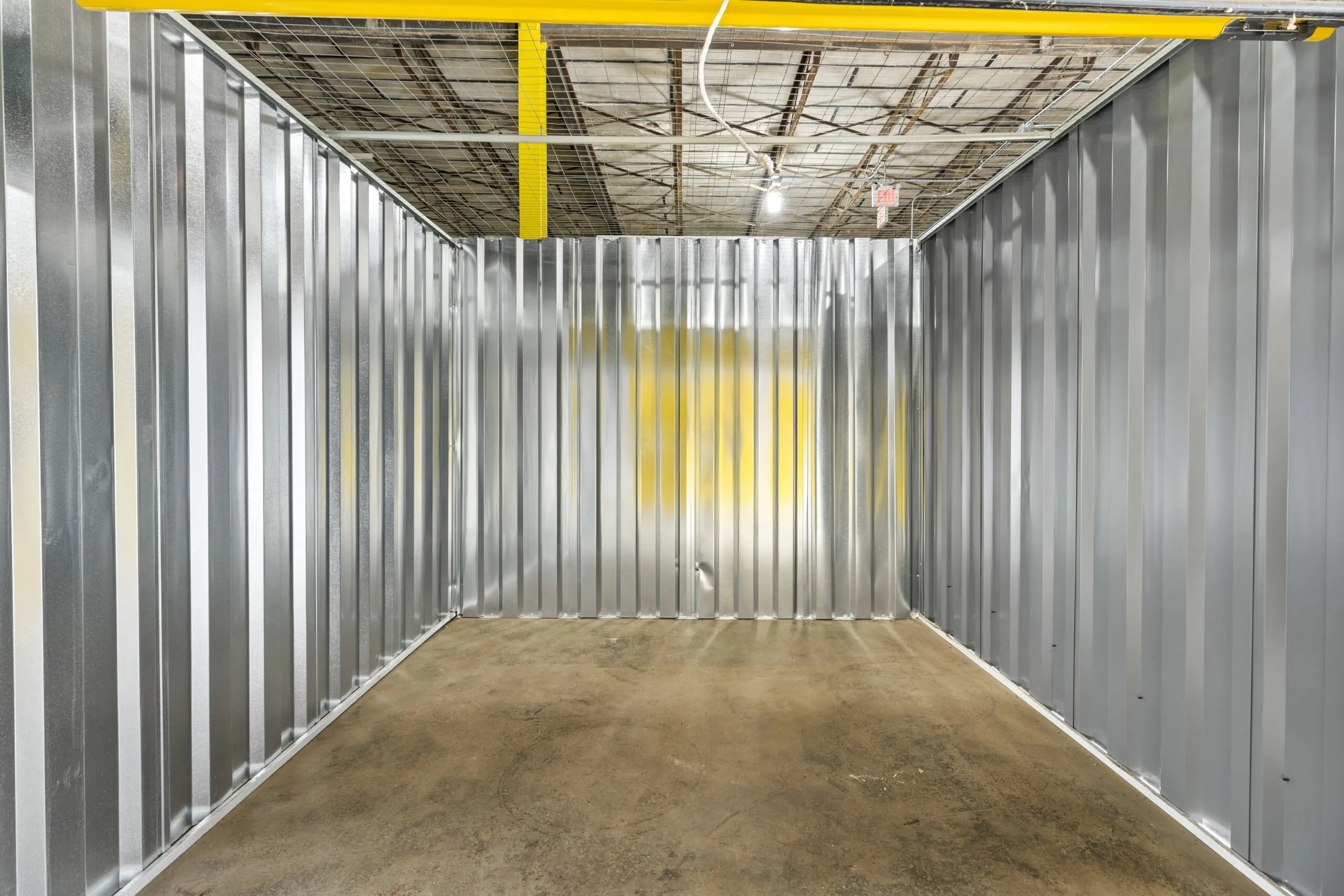 A room with metal walls and yellow accents.